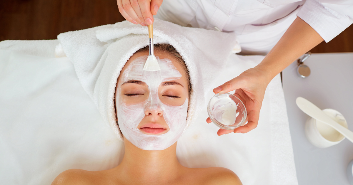 Woman receiving relaxing spa facials with white cream mask in Sykesville, MD